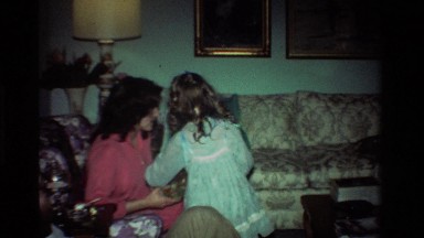 1981: A Mother Reading a Present to Her Child in California