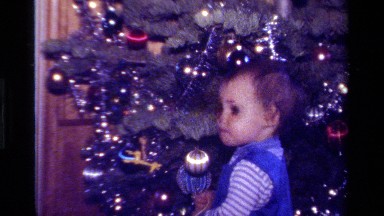 1979: Toddler Playing with Christmas Ornaments on Tree in California