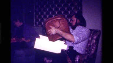 1979: Man and Older Lady Sit and Open Gifts Together in California