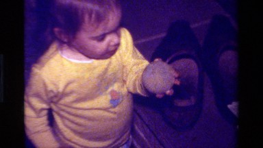 1979: Baby Playing With Yellow Ball in California Living Room