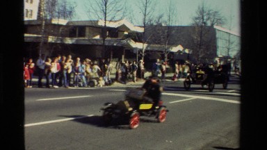 1981: An Older Man Drives a Classic Car Down a Street in California