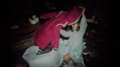 1981: A Girl Tries On A Pink And White Coat In California