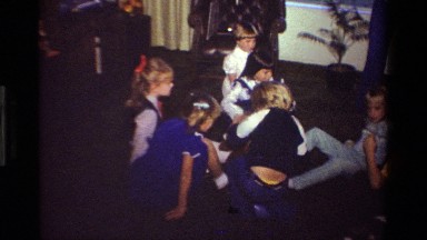 1981: kids in a circle playing trying to pop a balloon CALIFORNIA