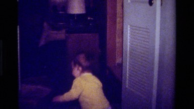 1979: Child Playing With White Doors In California Home