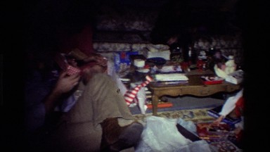 1981: Two People Opening Presents at Christmas in a Living Room
