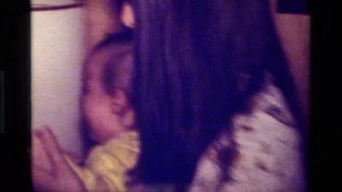 1979: Mom Putting Crying Baby Down on Floor California