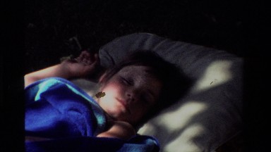 1981: Daytime Napping Child on Bed as Sun and Shade Pass Over Face, California