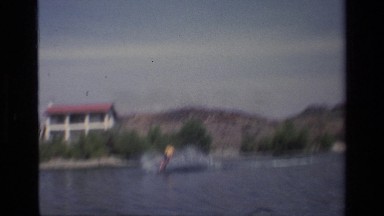 1977: Sea Spray Shoots Behind Motor Boat Pulling Jet Skier at Canyon Lake