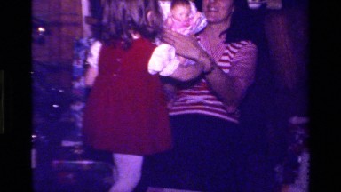 1979: child playing with baby doll CALIFORNIA