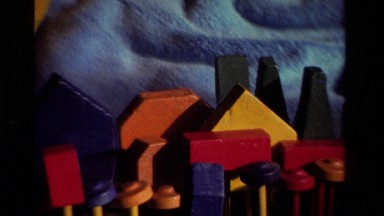 1981: A Little Girl Playing with a Toy Outside on a Blanket California