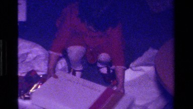 1979: girl opening a present with clothes CALIFORNIA