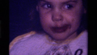 1979: toddler eating chocolate CALIFORNIA