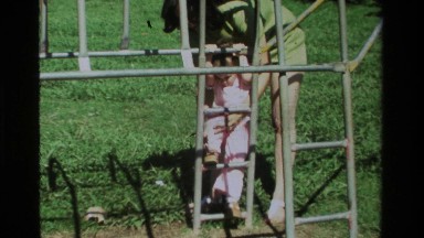 1979: a young lady plays on the jungle gym with a little girl CALIFORNIA