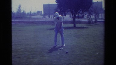 1977: a man in white hat is busy playing hockey game in playground LAGUNA BEACH