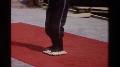 1984: an acrobat stands on a carton full of eggs without breaking them SINGAPORE