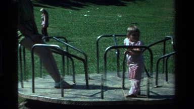 1979: a mom and her baby playing at the playground CALIFORNIA
