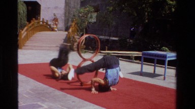 1984: A Couple of Gymnasts Perform Acrobatics with Hoops on the Floor in Thailand