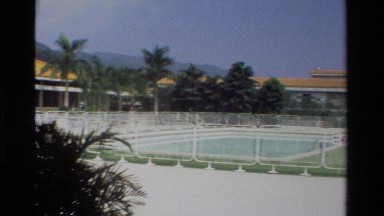 1984: a large pool sits behind a fence at a resort in asia HONG KONG