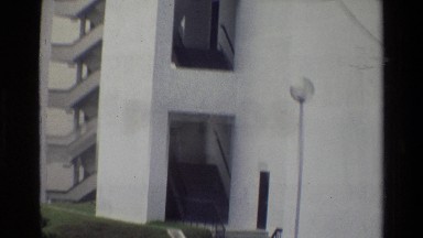 1984: A Woman Walking Toward a Tall Building in Singapore