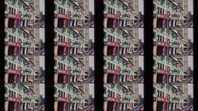 1984: People Cross Street in Large City at Leisurely Pace SINGAPORE