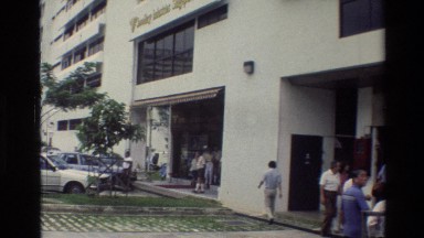 1984: People Walking Past a Hospital or Restaurant in Singapore