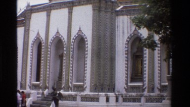 1984: a spire sit on top of an ornate roof piece on a temple THAILAND