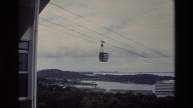1984: a trolley is moving in a long wire over the top of a city THAILAND