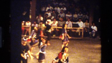 1984: people watching a dance performance by beautifully dressed men and women