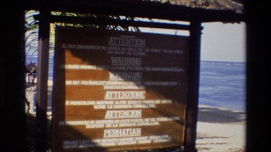 1984: A Brown Sign Provides a Warning to Visitors in Six Different Languages