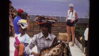 1984: natives hawk rugs and cloth products to tourists on a mountain overlook