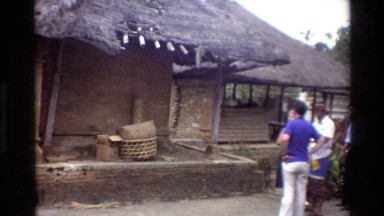 1984: People Standing Outside a Wooden House in Cambodia