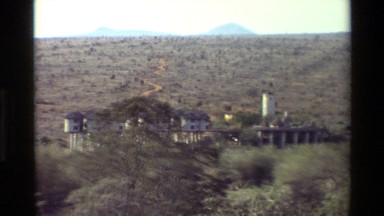 1983: A Group of Stilt Houses Sit in a Vast Dry Grass Field in Kilaguni