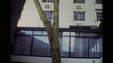 1983: a busy outdoor cafe sits at the base of a building