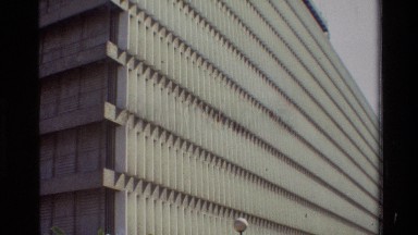 1983: front wall of modern building has repeated vertical and narrow bands