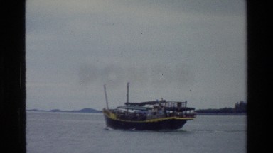 1984: A Large Boat Carrying People Moving on a River in Singapore