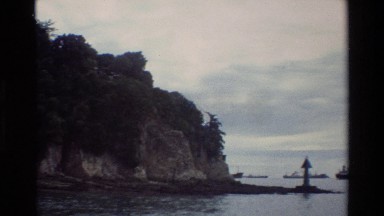 1984: Several Large Ships Anchored Off Shore a Rocky Cliff, Singapore