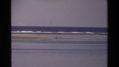 1984: A Lone Figure Walking in the Sea at Singapore