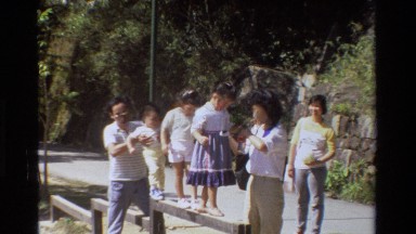 1984: a mom helping her daughter balance on a bar HONG KONG