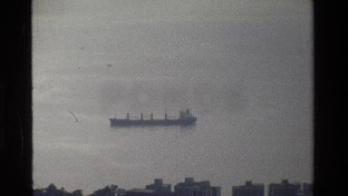 1984: a solitary ship floats in the sea on a cloudy day HONG KONG