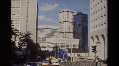 1984: cars driving past tall beautiful building in a city HONG KONG