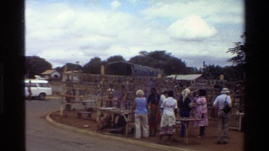 1983: Customers and Sellers Stand by Tables Near Racks at Mara Market