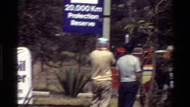 1983: a number of vehicles are placed in a large open area with people around