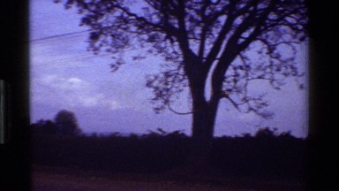 1983: a lady strolls alone down the street on a warm day KENYA