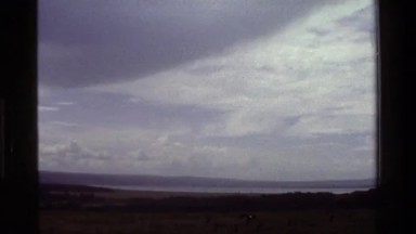 1983: Darkened Sky with Lake and Hills Beyond Kenya