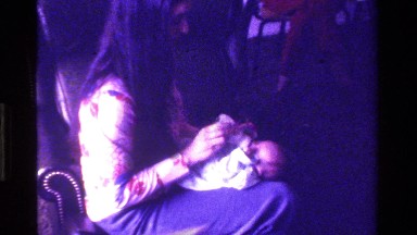 1975: woman feeding new baby CALIFORNIA