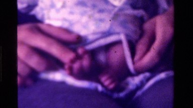 1975: close up of someone playing with infant's feet CALIFORNIA