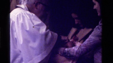 1975: A Mother Holding Her Baby During Baptism Ceremony in California Church