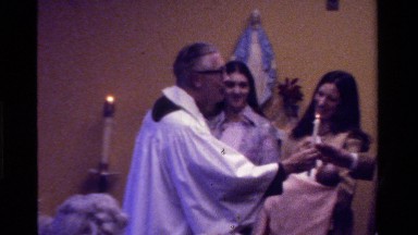 1975: father is giving away candles to a man and a woman in a church CALIFORNIA
