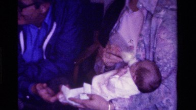 1975: an infant being bottle fed in the living room CALIFORNIA
