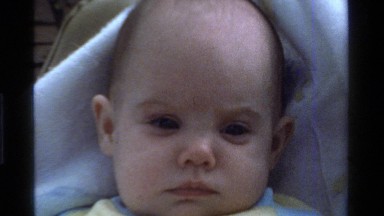 1975: a small kid sleeping on the bed with no people around CALIFORNIA